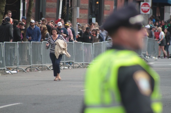 A spectator runs away from the scene of the explosions along the marathon route.
