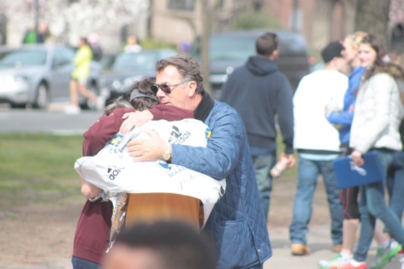 A family reunites with a runner after the explosion.