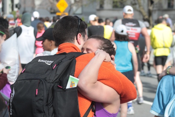 A runner who was stopped before she could finish the marathon reunites with loved ones on Commonwealth Ave.