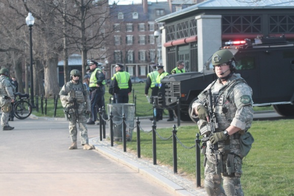 Metro SWAT officers maintain a security perimeter around a group of about 100 members of the National Guard.