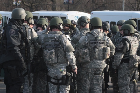 A group of Metro SWAT officers gather for a briefing in Boston Common.